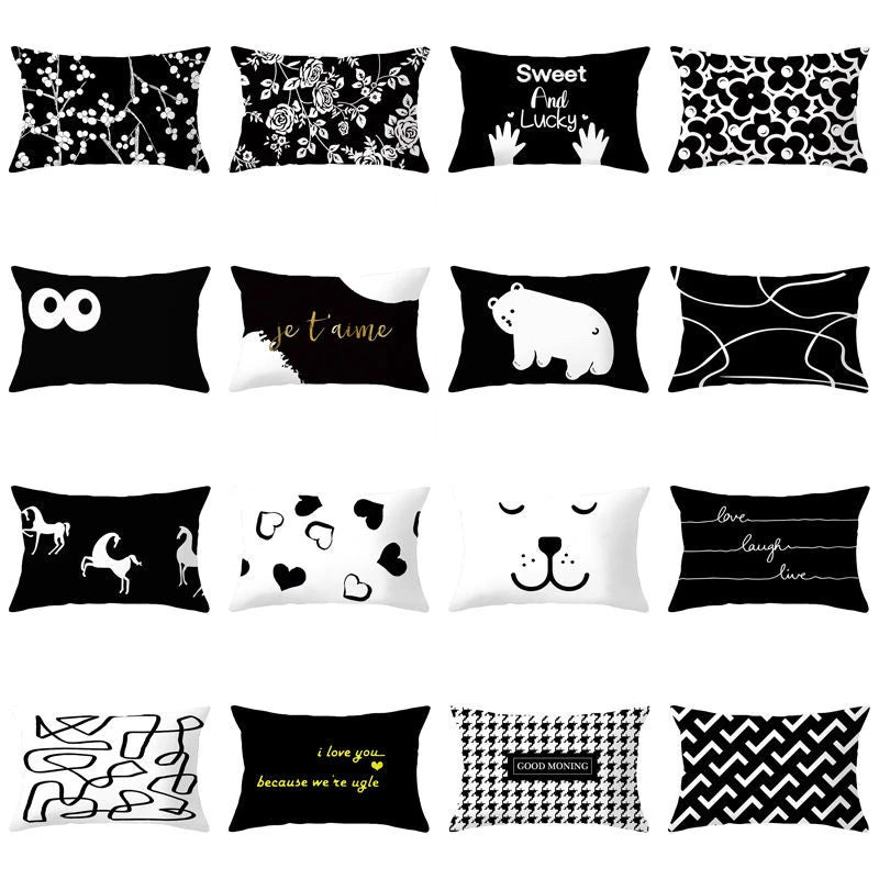 A collection of black and white decorative pillow covers featuring various patterns including floral designs, text, and anima