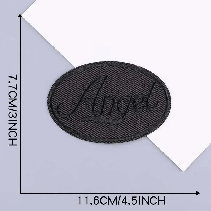 A black oval embroidered leather patch with the word Angel on it, shown against a white background.