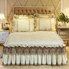 A set of three bed skirts and pillowcases in cream and brown lace fabric with quilted bedding.