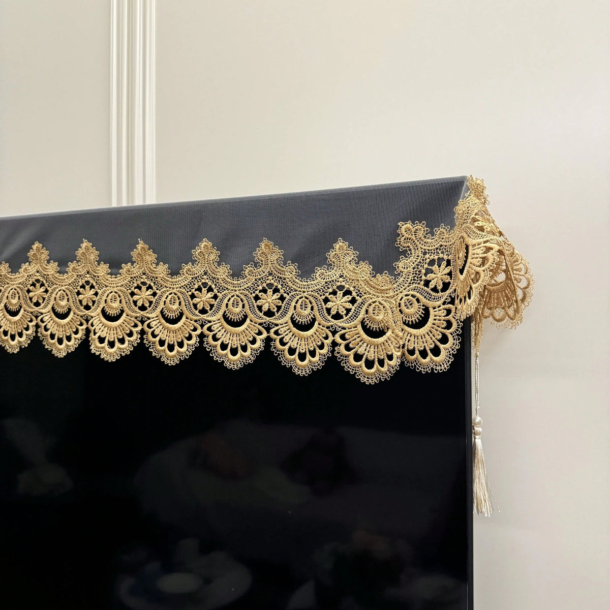 Black table runner featuring intricate gold embroidered mesh lace trim.