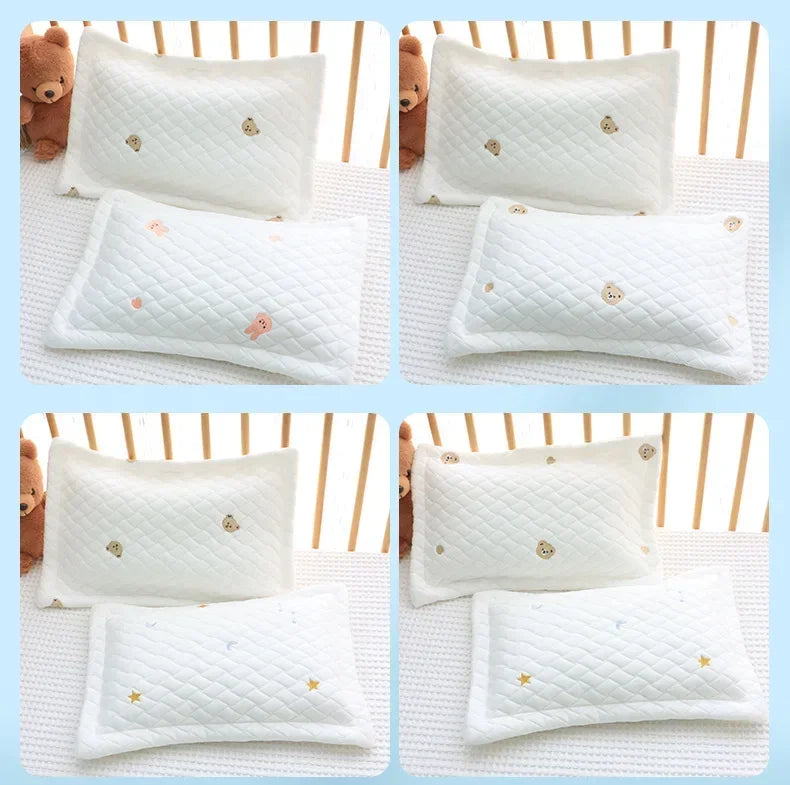 White quilted soft cooling pillows with gold accents for newborns and babies