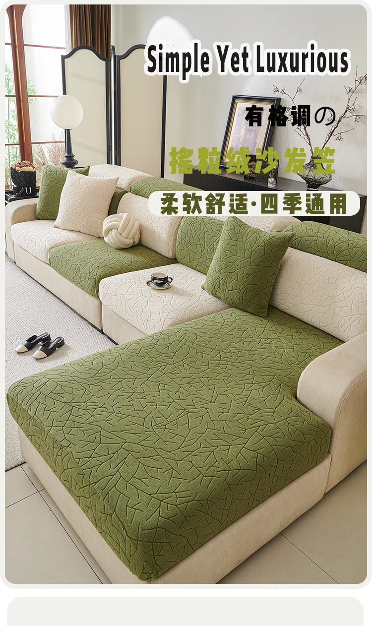 A light beige sofa covered with a green branch patterned jacquard fabric and matching cushions.