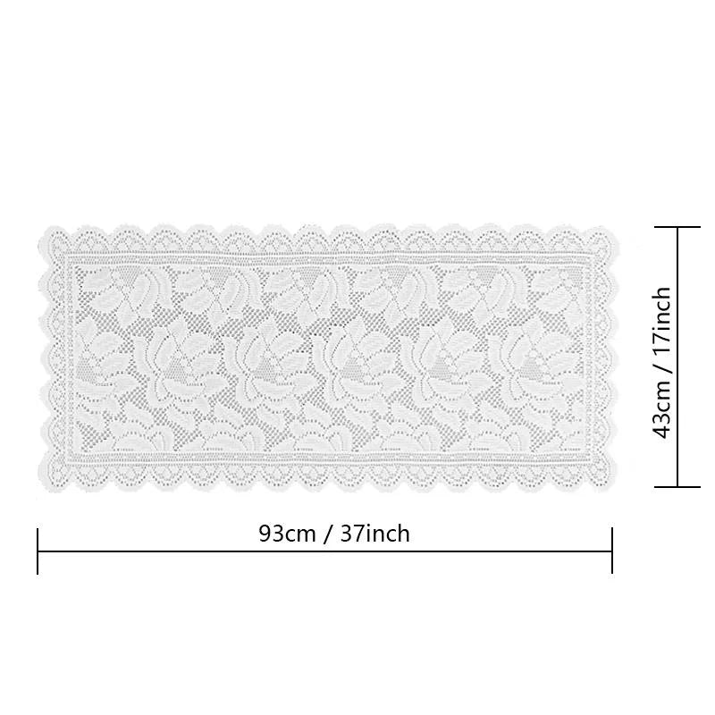 White lace table runner featuring a delicate floral pattern and scalloped edges.