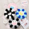 A collection of cozy sunflower plush cushions in various colors including pink, black, white, and blue.