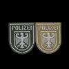 Two embroidered patches featuring an eagle shield design on a dark background.