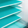 A close-up view of multiple teal reusable EVA fridge shelf liners stacked in a white organizer.