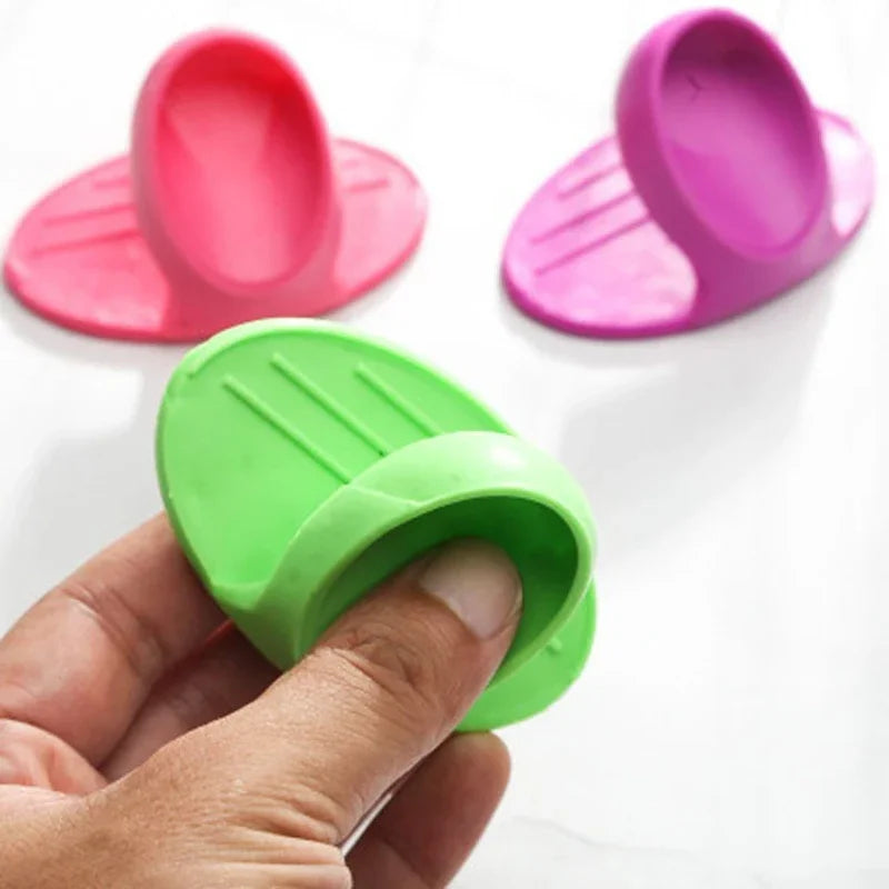 Three silicone oven mitts in pink and green colors are shown, with one being held by a hand.