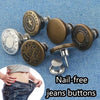A set of metal jeans buttons and a screwdriver for nail-free jean button repair.