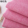 Stack of pink coarse linen and cotton fabric rolls