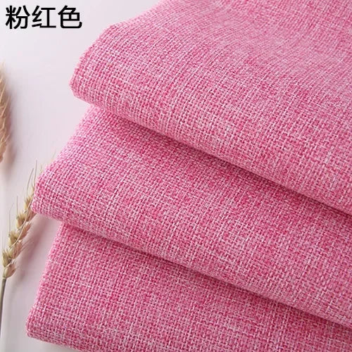 Stack of pink coarse linen and cotton fabric rolls