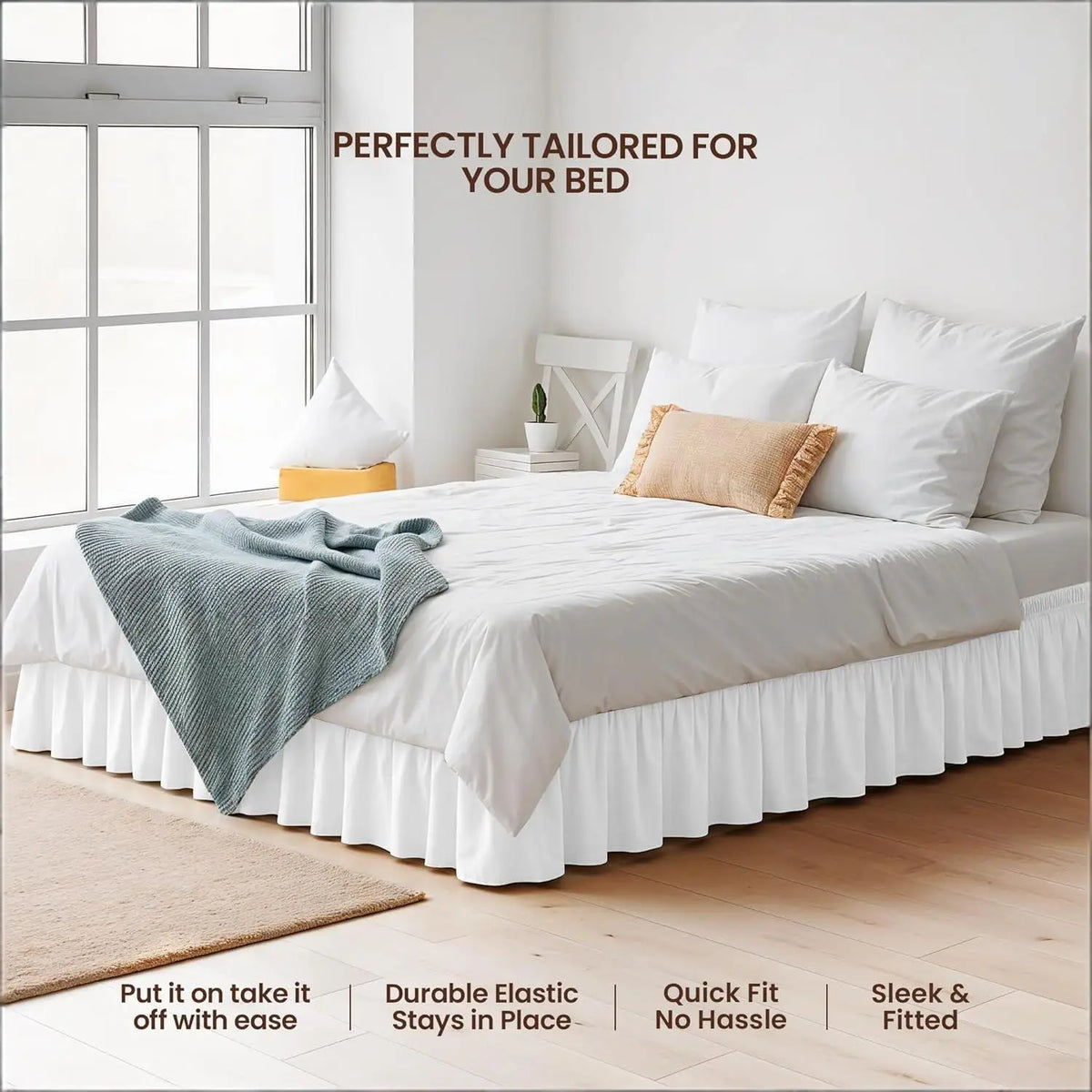 White bed with a ruffled skirt and bedding set on a wooden floor.