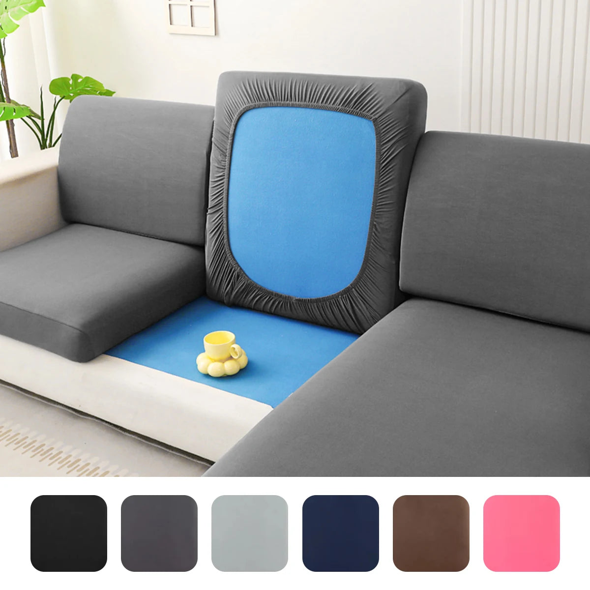 A solid gray elastic sofa cushion slipcover with a blue accent and yellow decorative balls.