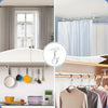 A collection of no-drill adhesive curtain hooks in various colors and sizes displayed on a shelf.