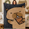 A plush flannel blanket featuring a cartoon bear drinking from a coffee cup.
