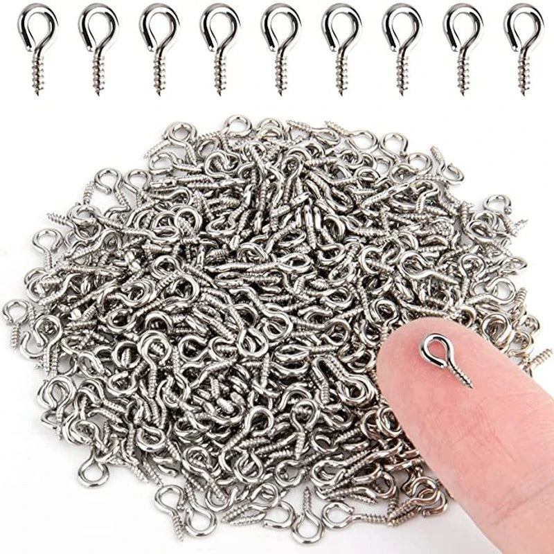 A pile of stainless steel eye screw pins for jewelry making, showing various sizes and styles.