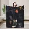 A dark graphic throw blanket featuring multiple portraits of male characters in a moody style.