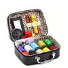Portable sewing kit in a black box with a leopard print lining, containing various needles and thread.
