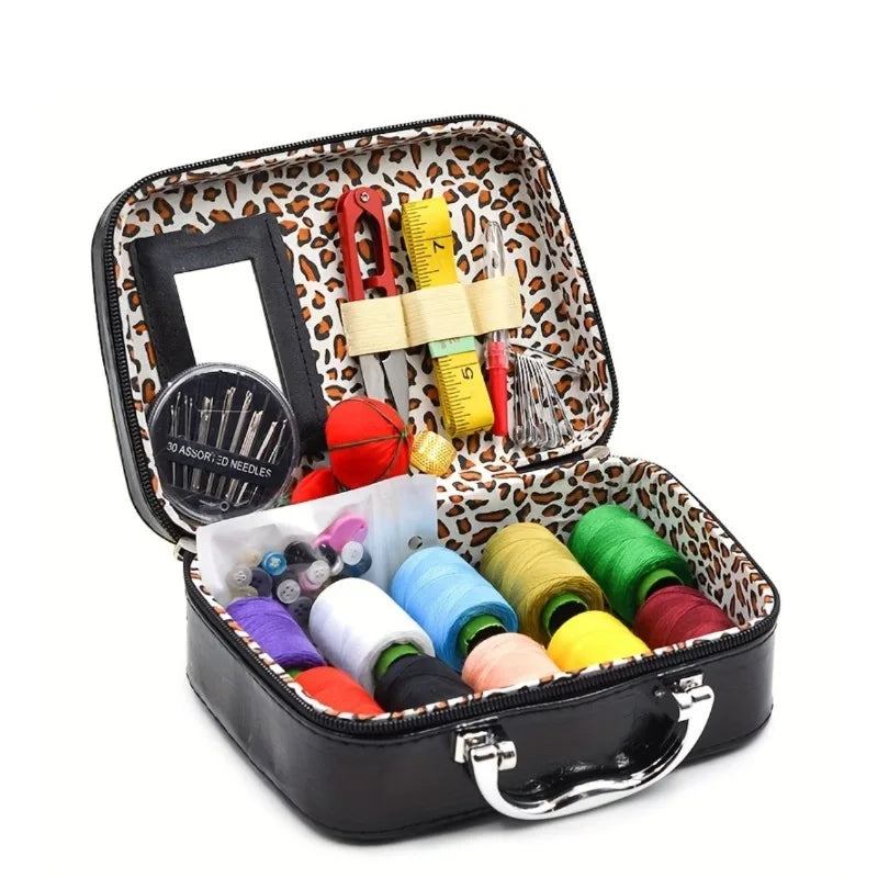 Portable sewing kit in a black box with a leopard print lining, containing various needles and thread.