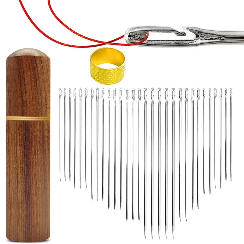 A precision self-threading sewing kit showing a wooden bobbin, a gold ring, and multiple silver needles.