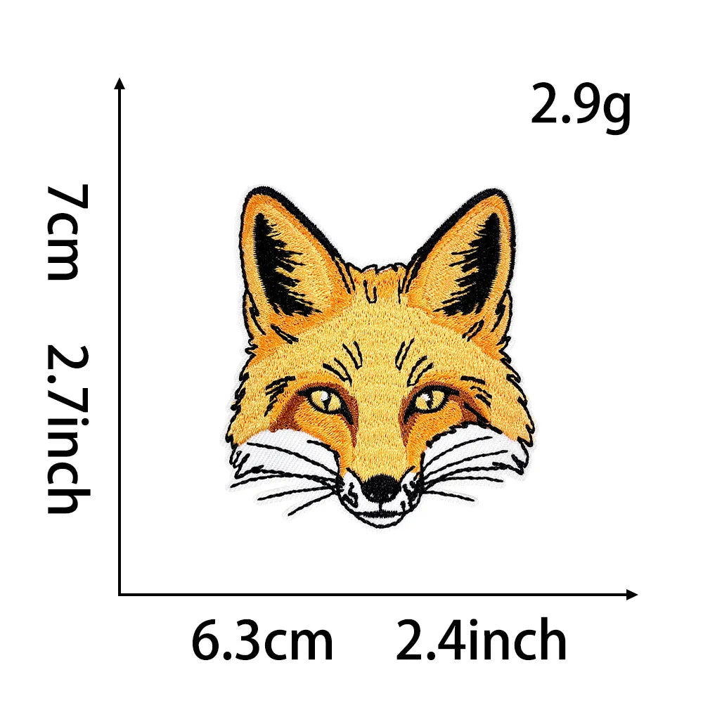 An embroidery patch depicting a fox face with orange and white fur on a light background.