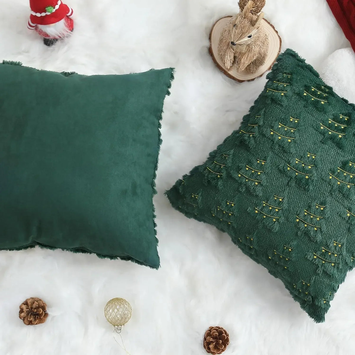 A dark green textured corduroy throw pillow cover resting on a white fluffy surface with small natural elements.