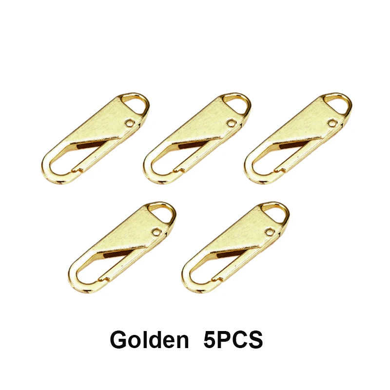 Five gold metal zipper sliders or repair kits.