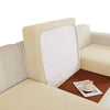 A beige sofa seat protector cushion cover with a white insert is shown on a brown surface.
