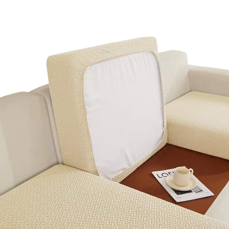 A beige sofa seat protector cushion cover with a white insert is shown on a brown surface.