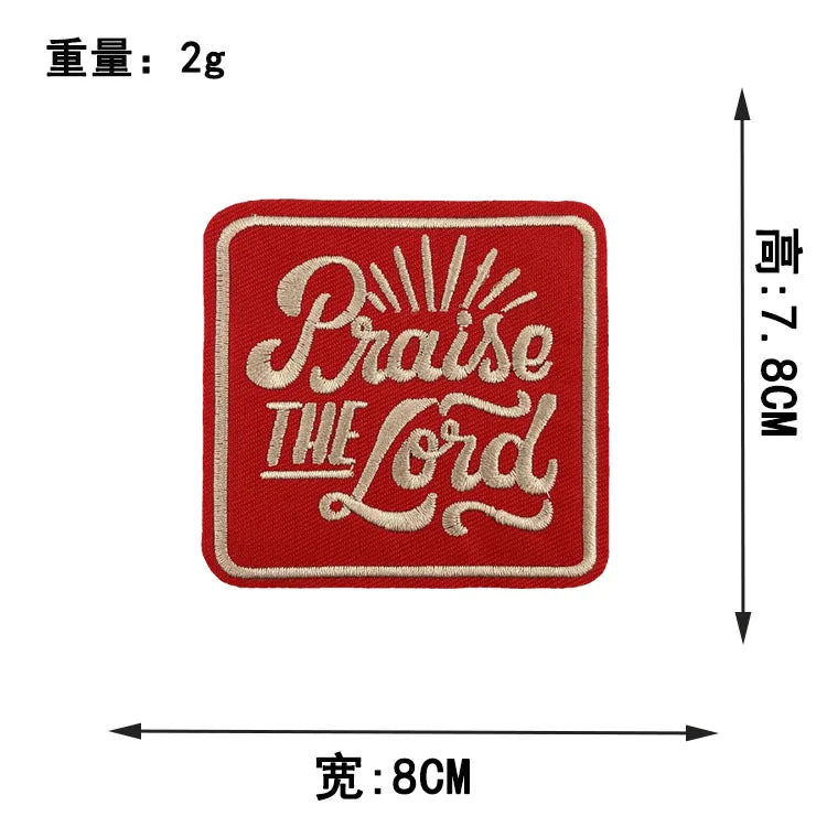 Red embroidered patch with the text Praise The Lord on a white background