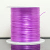A spool of purple multicolor elastic beading cord on a white stand.