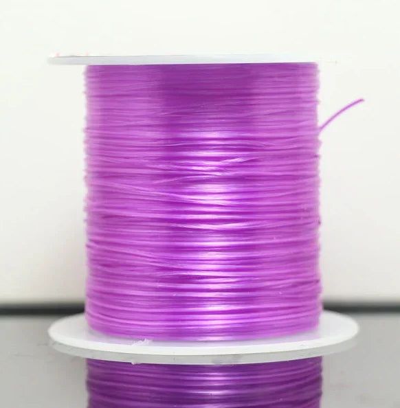 A spool of purple multicolor elastic beading cord on a white stand.