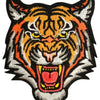 An embroidered patch featuring a fierce orange and black tiger head with yellow eyes and an open mouth.