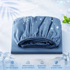 A folded blue cooling fitted sheet with elastic edges displayed on a white surface.