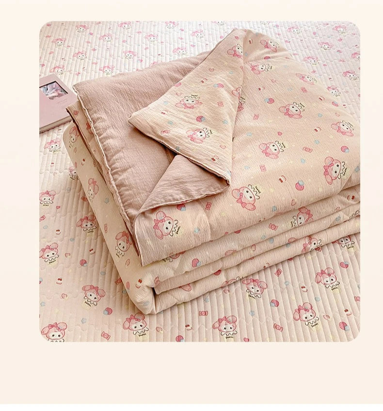 A stack of light pink cartoon quilting comforters with small pink and white floral patterns on a light pink quilted backgroun