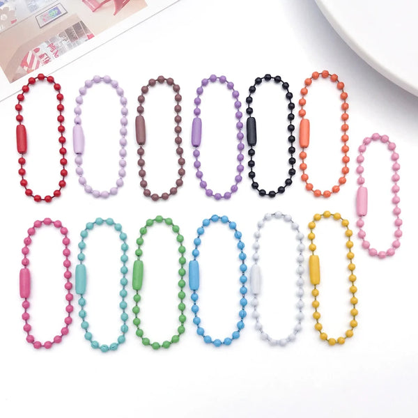 A collection of colorful metal ball bead chains in various colors and lengths for DIY jewelry making.