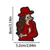 A red felted cartoon patch of a woman with long brown hair wearing a red hat and holding food.
