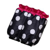 A black polka dot ruffle apron with pink trim and pockets.