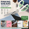 A pair of professional pinking shears with a white and green ergonomic grip shown next to various fabric and craft materials.