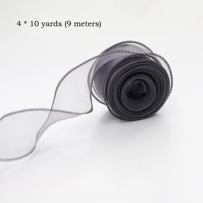 A roll of sheer gray organza ribbon, measuring 4 times 10 yards (9 meters), shown unwound.