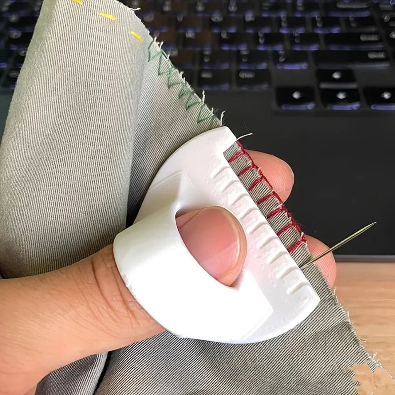 A hand holds a white sewing guide tool with 3mm spacing against a gray fabric.