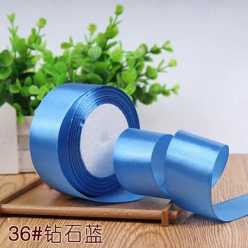 Roll of 4 cm wide satin ribbon in blue for gift wrapping and DIY crafts