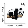 A black and white panda embroidery patch measuring 2.4g, shown resting on a tan fabric background.