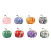 A collection of seven handcrafted natural stone pumpkin figurines in various colors including pink, blue, orange, yellow, sil