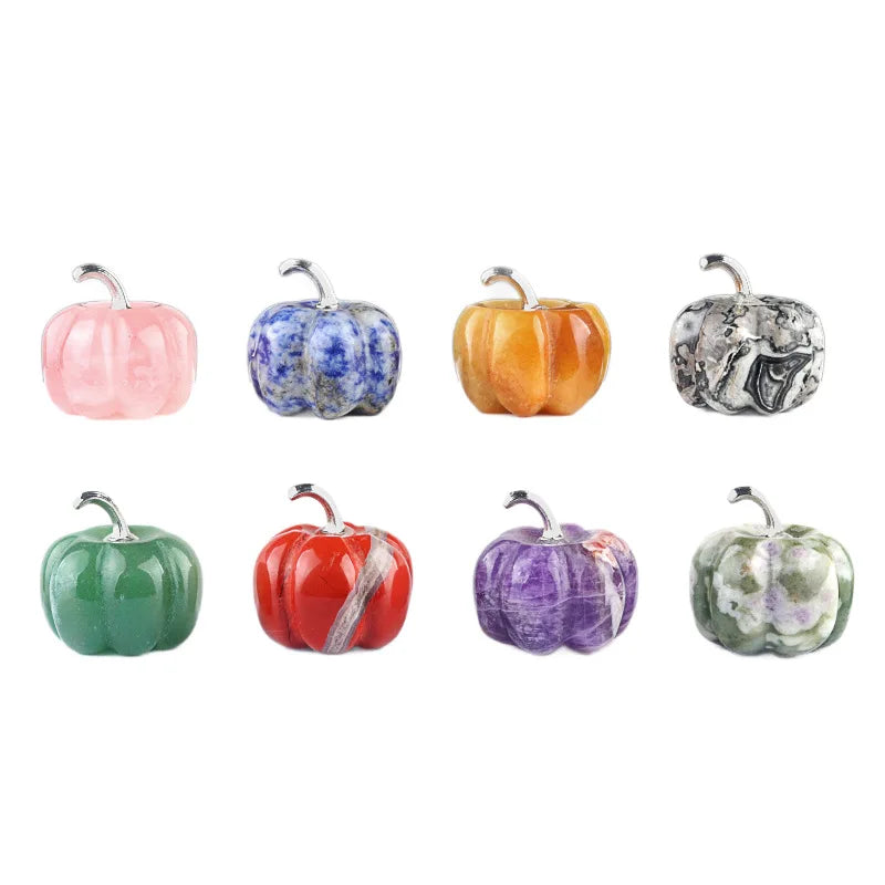 A collection of seven handcrafted natural stone pumpkin figurines in various colors including pink, blue, orange, yellow, sil