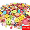 A pile of assorted resin sewing buttons in various colors and shapes for crafting projects