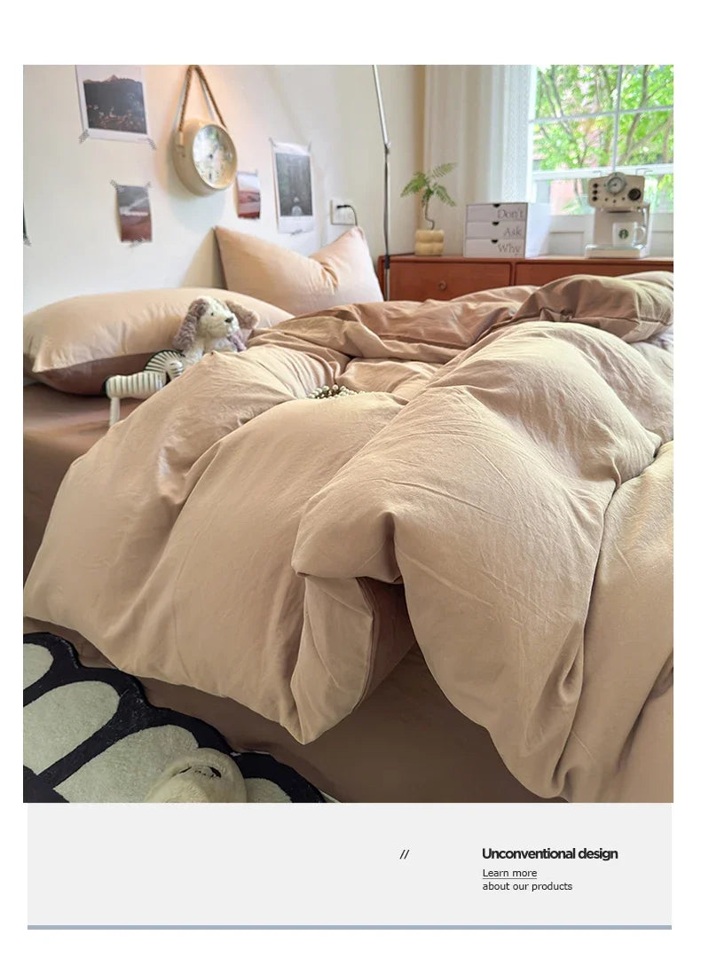 A beige ultra-soft washed cotton quilt bedding set on a bed with natural light and wooden furniture.