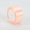 A roll of peach satin ribbon, 4cm wide, used for crafts and gift wrapping.