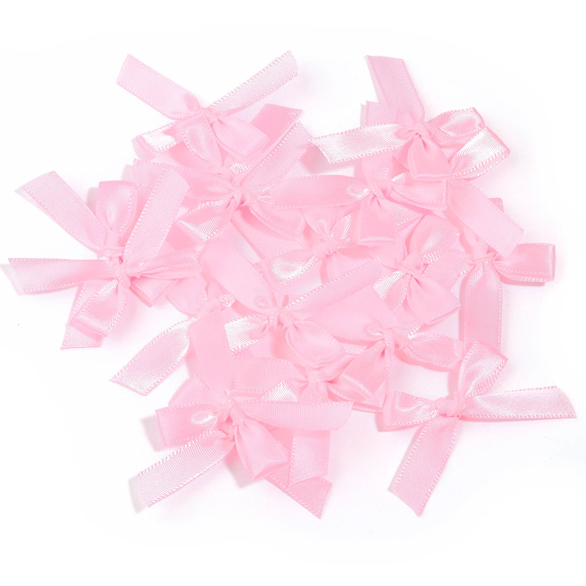 A pile of pink satin ribbon bows for craft and decoration