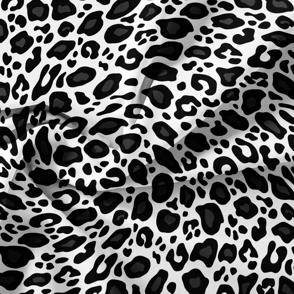 A close-up of a luxury leopard print duvet cover set with black and white spots.