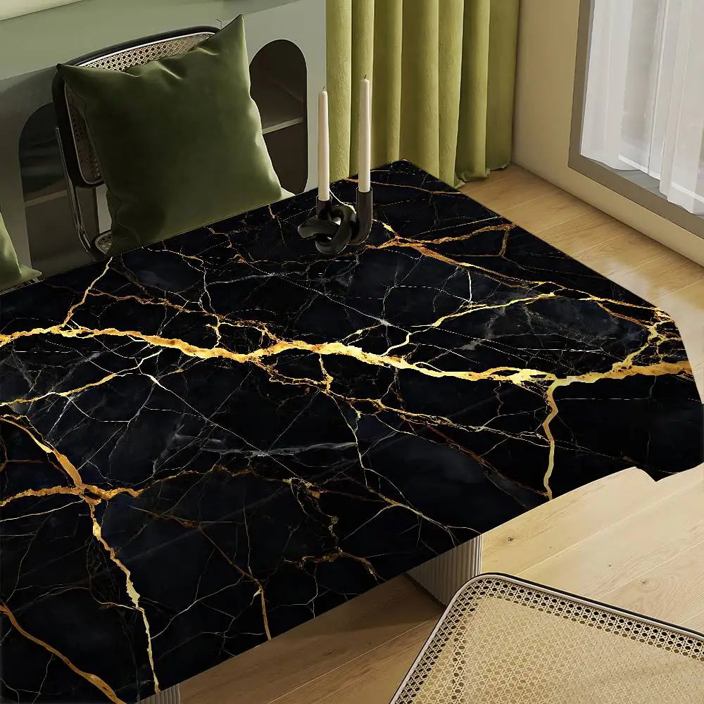 A black marble table cloth with gold veining is displayed on a wooden table.